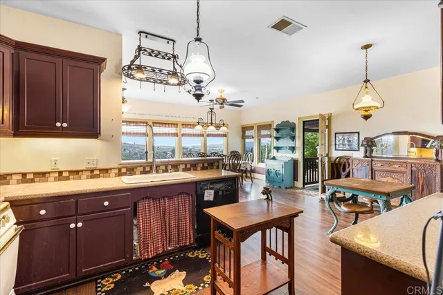 a kitchen with a table chairs stove and cabinets