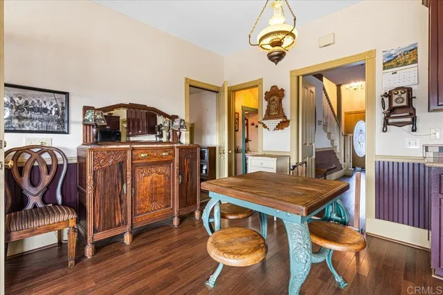 a dining room with furniture and wooden floor