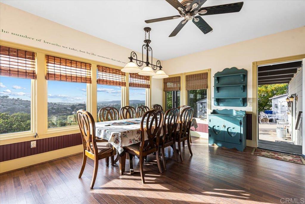 333 Salmon Road Ramona, CA 92065 - Photo 5 of 44 a dining room with wooden floor a chandelier a wooden table and chairs