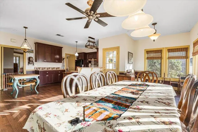 a bedroom with a bed a chandelier and a flat screen tv
