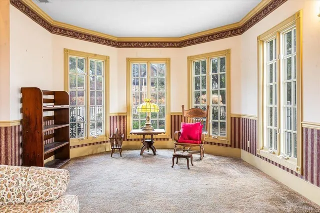 a living room with furniture and floor to ceiling window