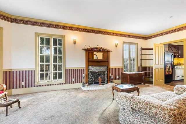 a living room with furniture and large windows