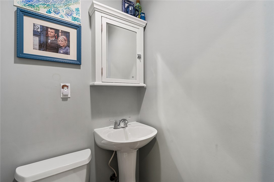 512 East Fredericks Street Anderson, SC 29621 - Photo 12 of 31 A well-appointed lavatory featuring a pristine white pedestal sink and wall-mounted storage.