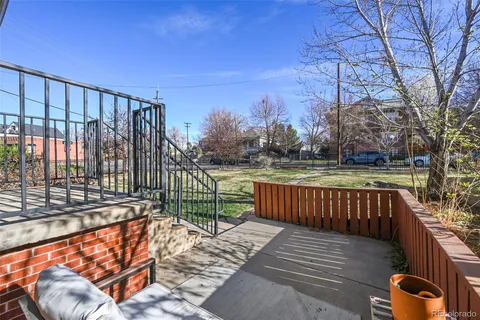 a view of a roof deck with wooden fence and wooden floor