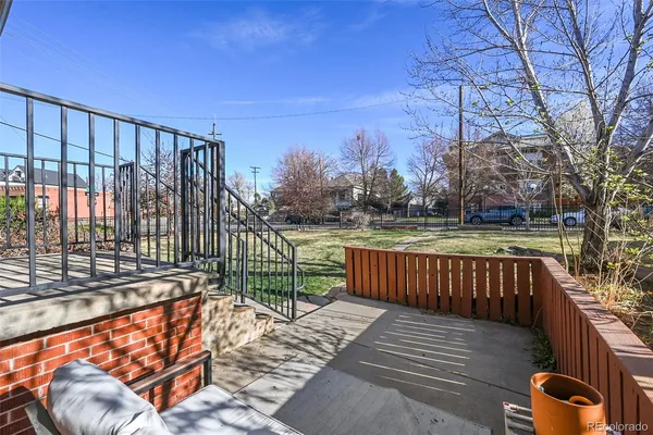a view of a roof deck with wooden fence and wooden floor