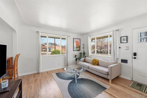 a living room with furniture a rug and a flat screen tv