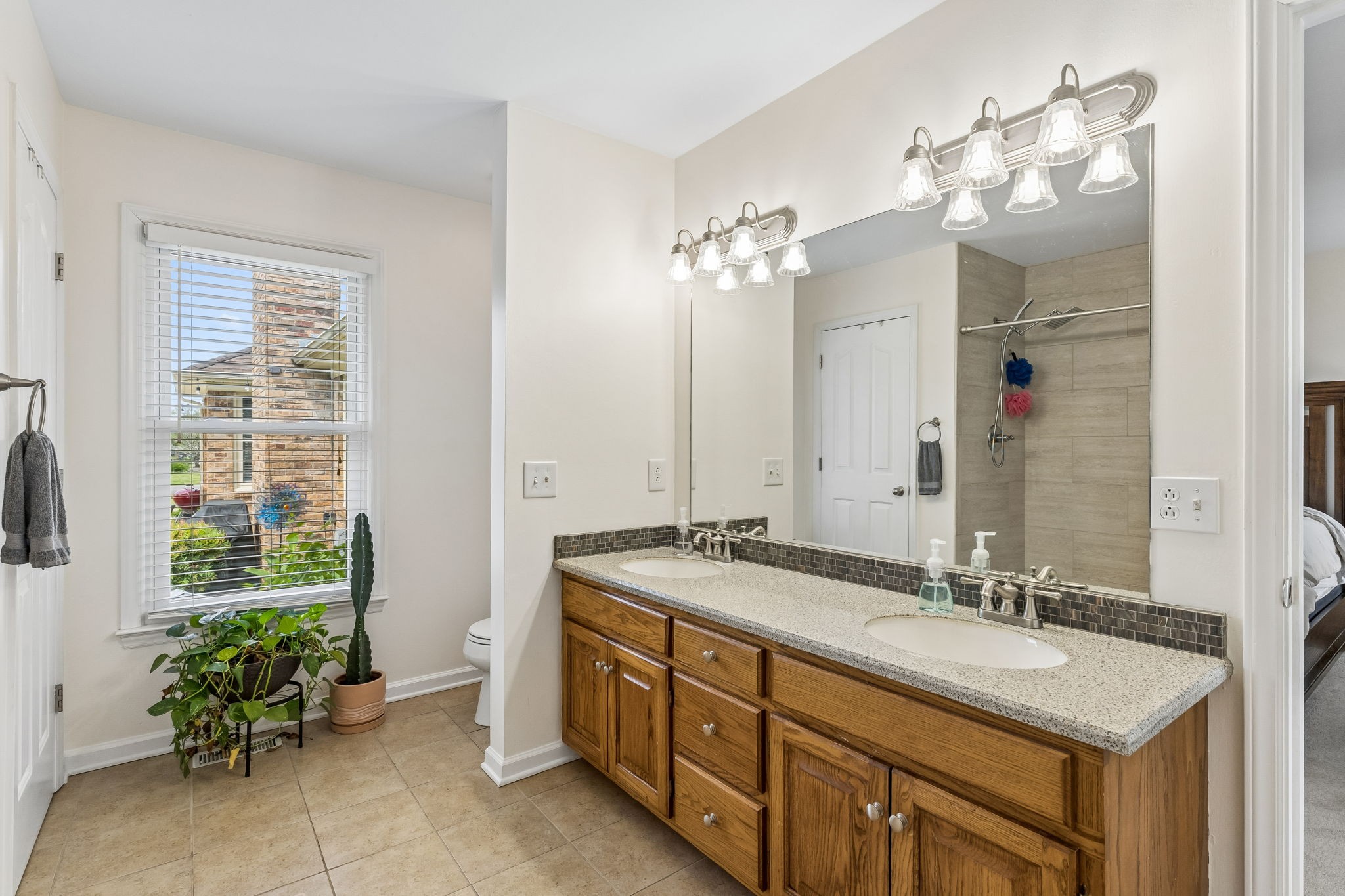 2104 Red Mile Road Murfreesboro, TN 37127 - Photo 16 of 28 a spacious bathroom with a granite countertop sink a large mirror and a shower