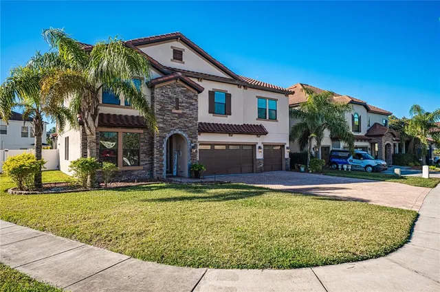 a view of a house with swimming pool and a yard