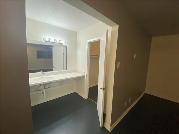 a bathroom with a sink a vanity and a mirror