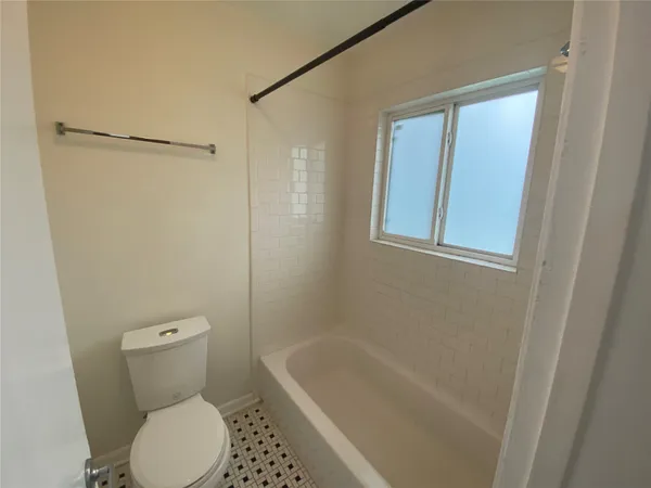 a bathroom with a toilet and a bathtub