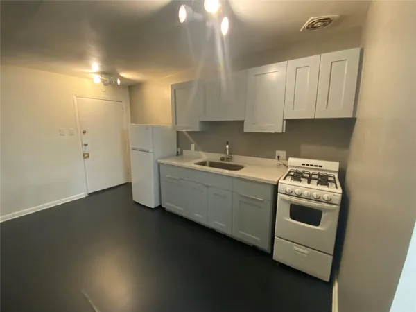 a kitchen that has a sink and a stove