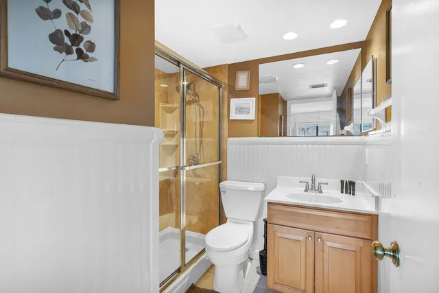 a bedroom with a bed window and dresser