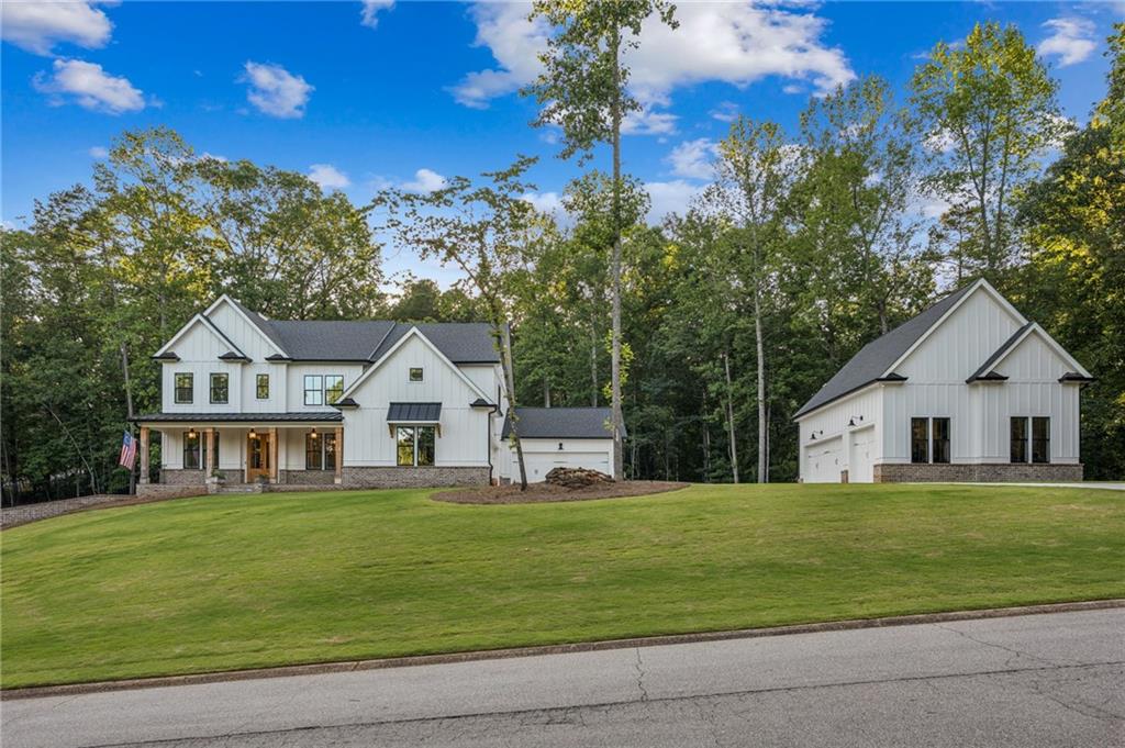 6326 Point Twenty Two Gainesville, GA 30506 - Photo 2 of 92 a front view of a house with a garden and yard