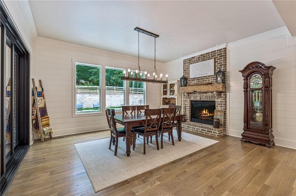 6326 Point Twenty Two Gainesville, GA 30506 - Photo 26 of 92 a dining room with furniture a chandelier and wooden floor