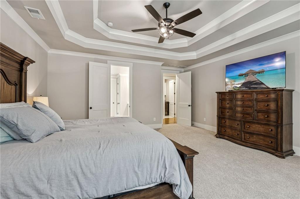 6326 Point Twenty Two Gainesville, GA 30506 - Photo 36 of 92 a bedroom with a bed a dresser and a chandelier