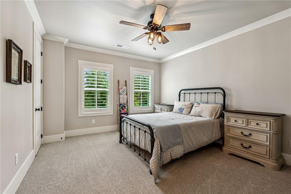 6326 Point Twenty Two Gainesville, GA 30506 - Photo 45 of 92 a bedroom with a bed a chandelier and a window