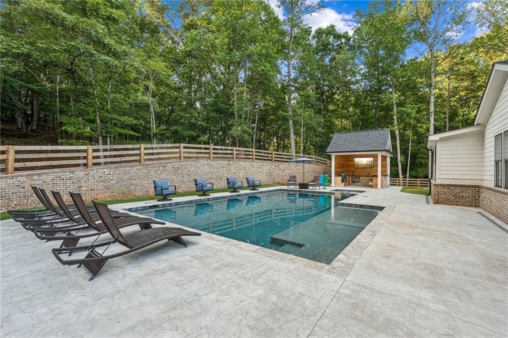 6326 Point Twenty Two Gainesville, GA 30506 - Photo 56 of 92 a view of a patio with table and chairs a barbeque with wooden fence