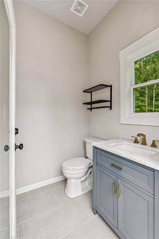 6326 Point Twenty Two Gainesville, GA 30506 - Photo 62 of 92 a bathroom with a granite countertop toilet a sink and a window