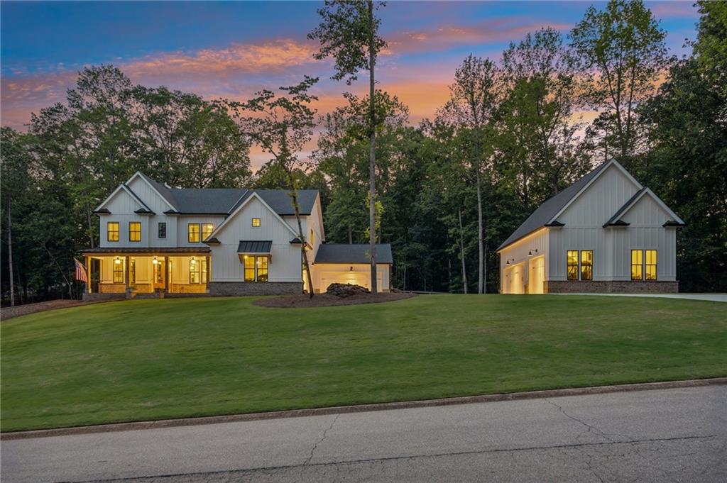 6326 Point Twenty Two Gainesville, GA 30506 - Photo 70 of 92 a front view of a house with a yard and garage
