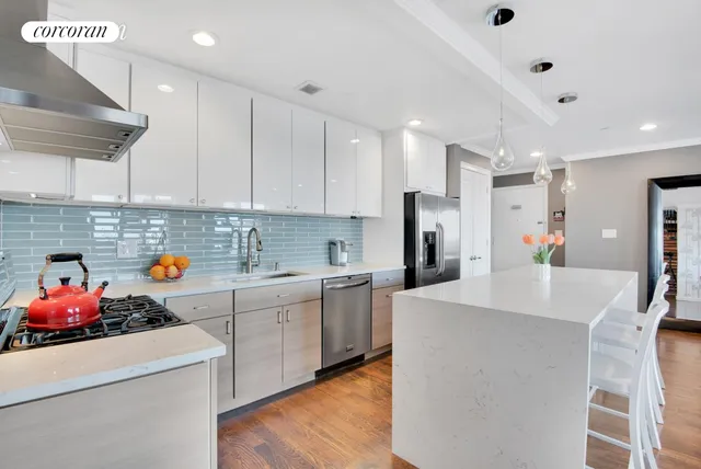 a kitchen with a sink white cabinets and white appliances