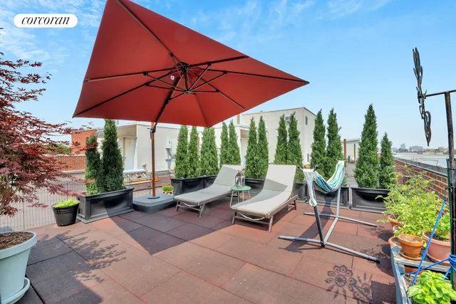 a view of a tables and chairs under an umbrella in patio