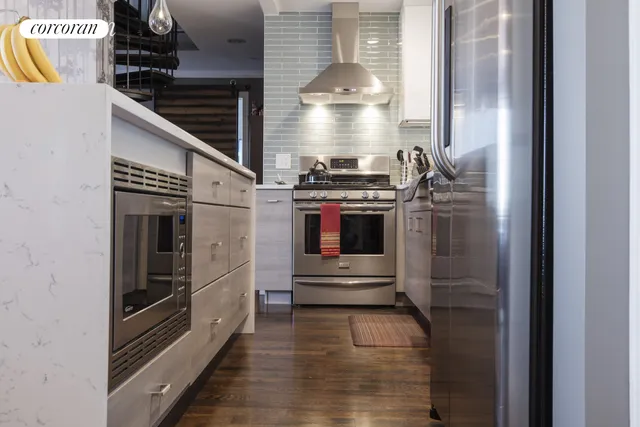 a kitchen with stainless steel appliances kitchen island a stove and a refrigerator
