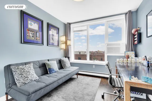 a living room with furniture a window and a flat screen tv