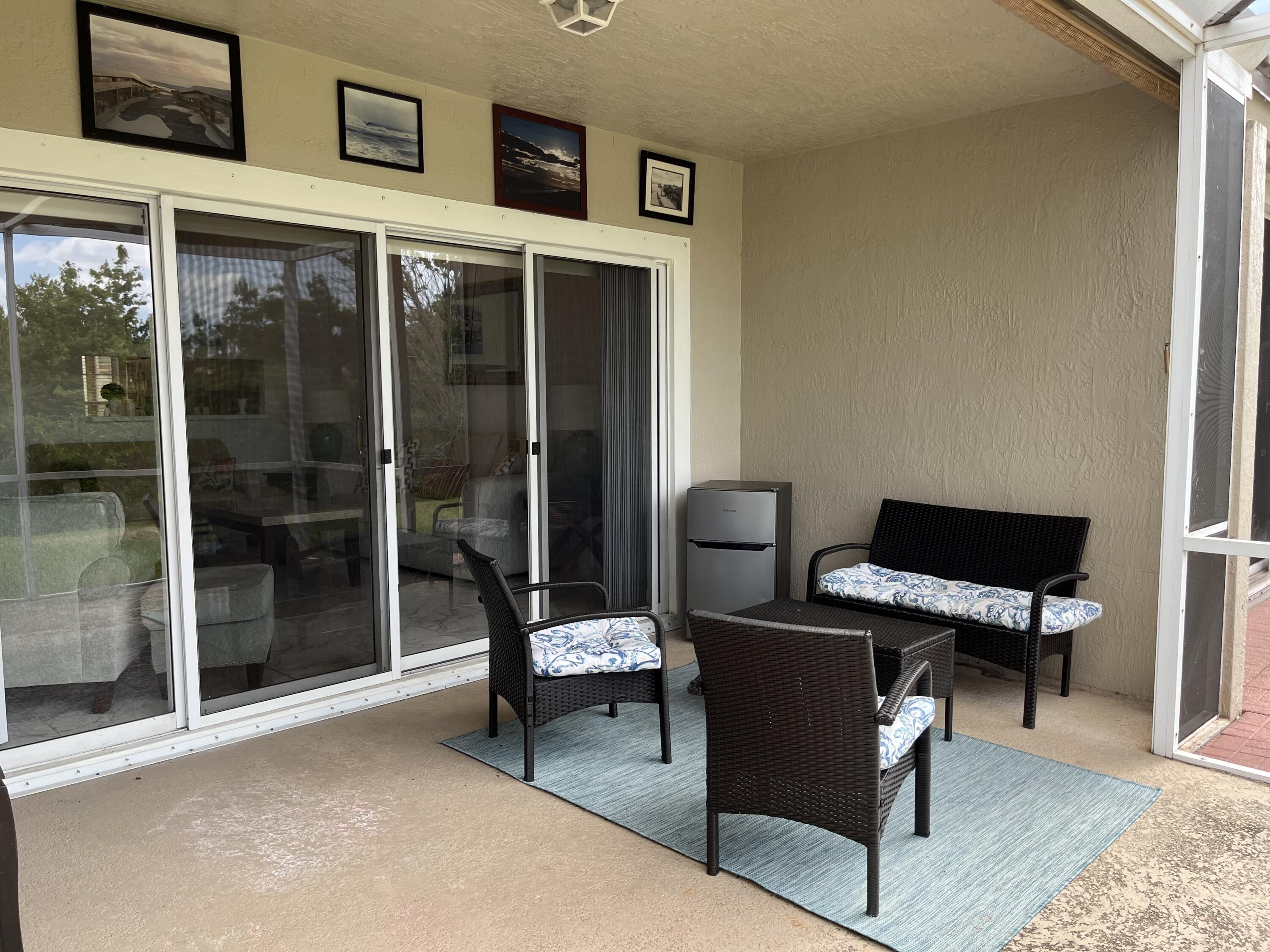 21105 Vía Solano Boca Raton, FL 33433 - Photo 14 of 14 a building outdoor space with patio furniture and potted plants