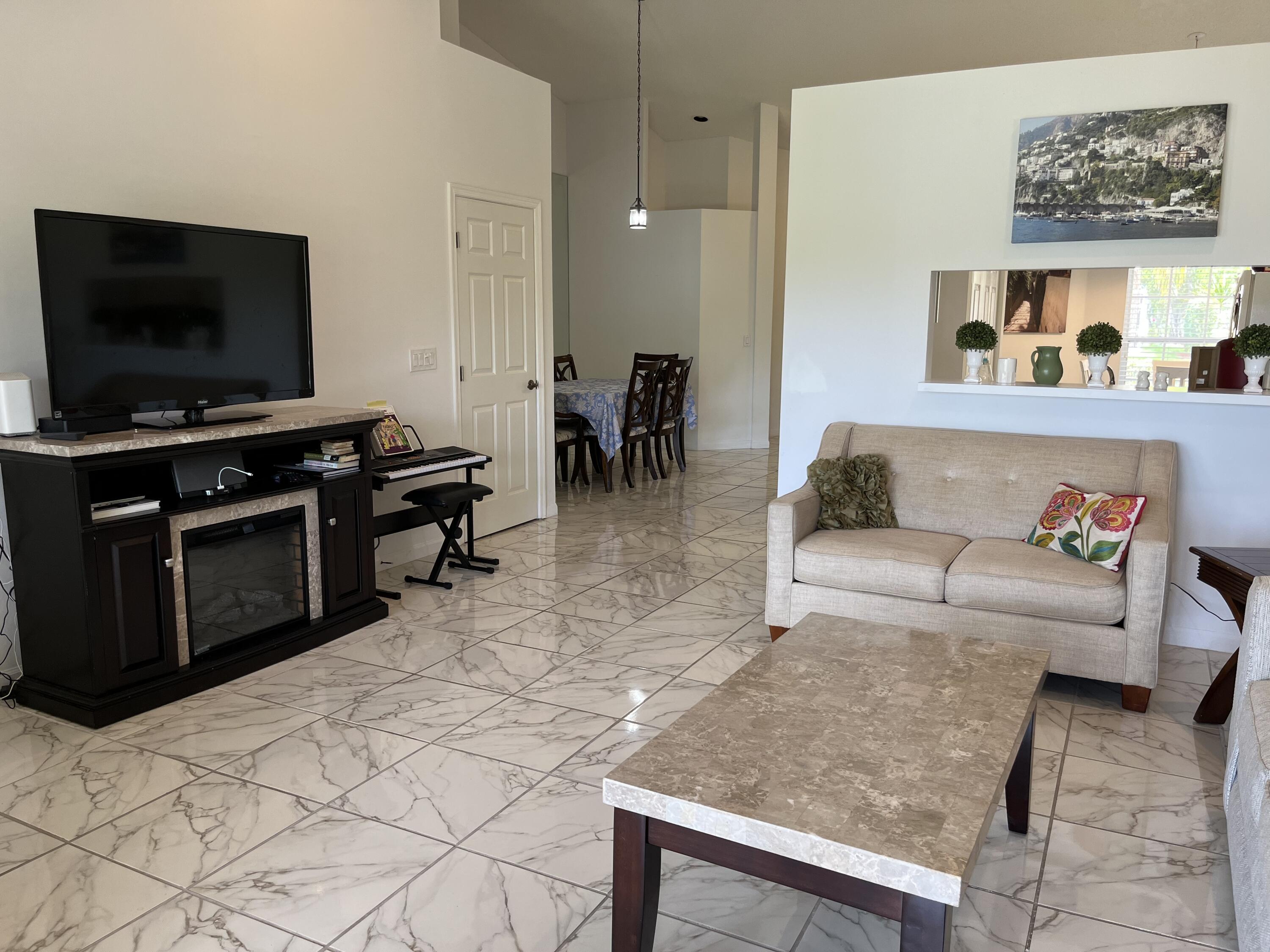 21105 Vía Solano Boca Raton, FL 33433 - Photo 6 of 14 a living room with furniture and a flat screen tv