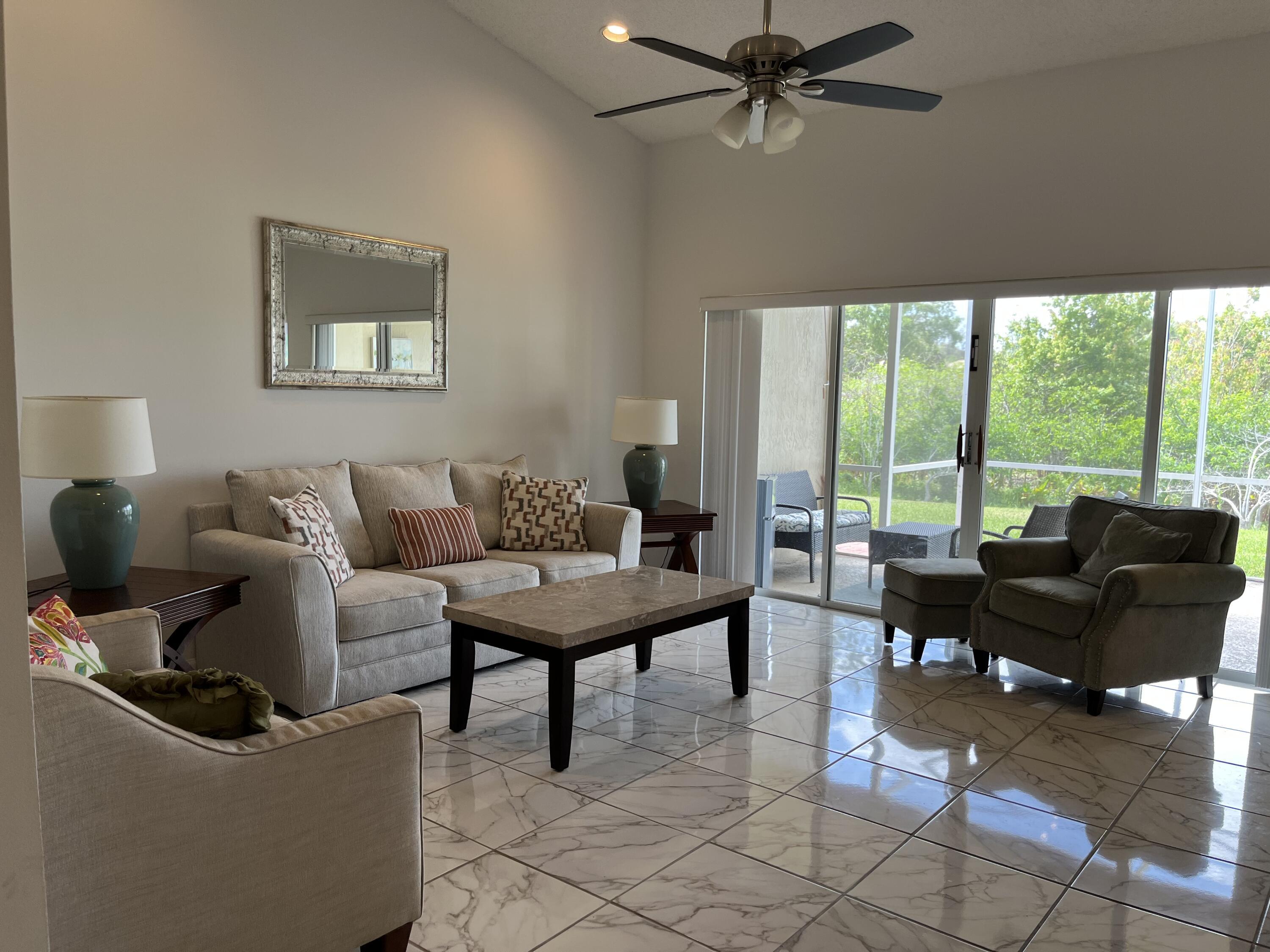 21105 Vía Solano Boca Raton, FL 33433 - Photo 7 of 14 a living room with furniture and a floor to ceiling window