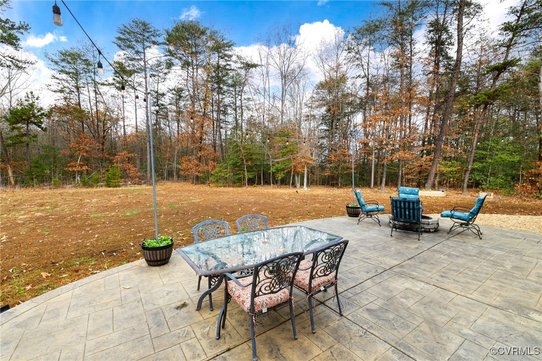 2802 Perkinsville Road Maidens, VA 23102 - Photo 30 of 40 a view of a patio with table and chairs and wooden fence