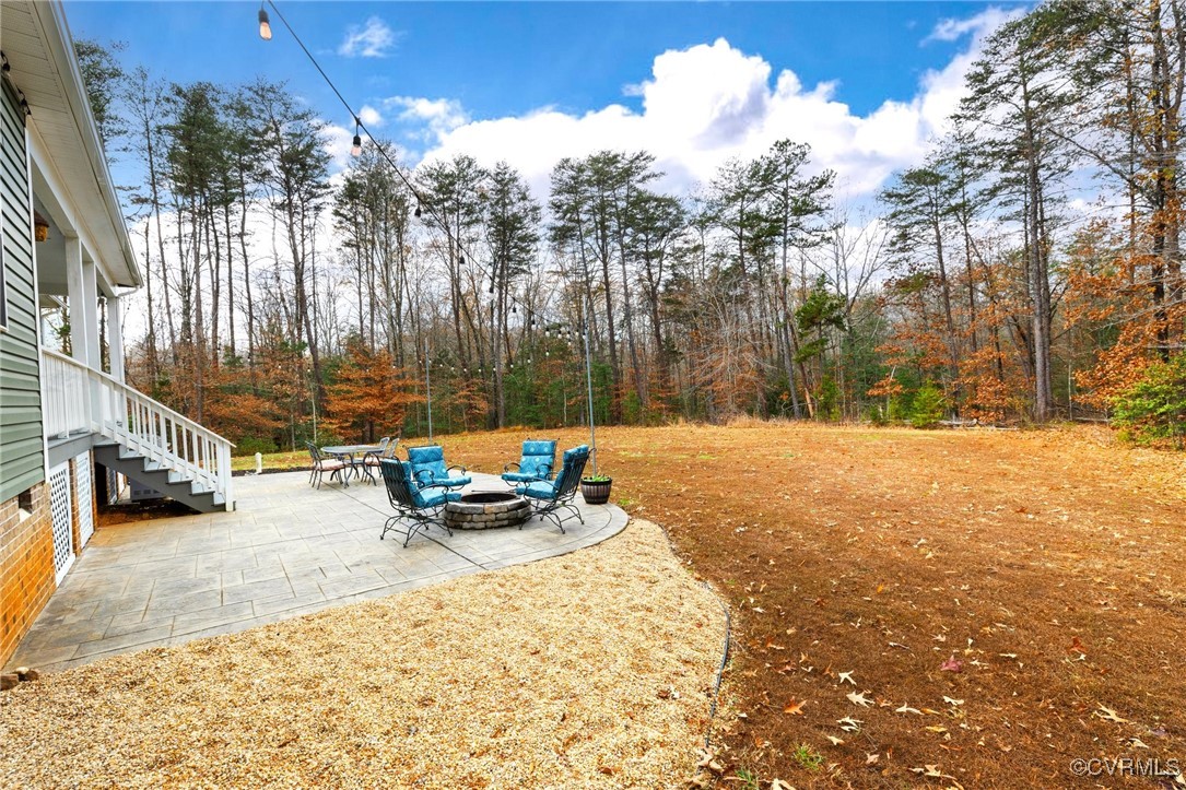 2802 Perkinsville Road Maidens, VA 23102 - Photo 33 of 40 View of yard featuring a fire pit and a patio area