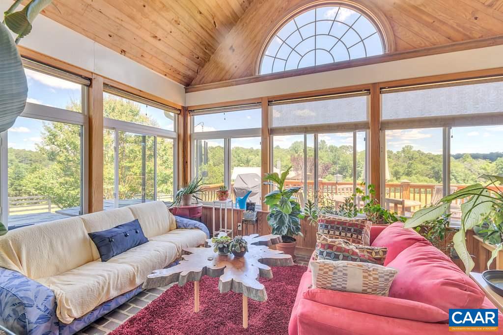 846 Troy Road Troy, VA 22974 - Photo 29 of 49 a living room with furniture and floor to ceiling windows