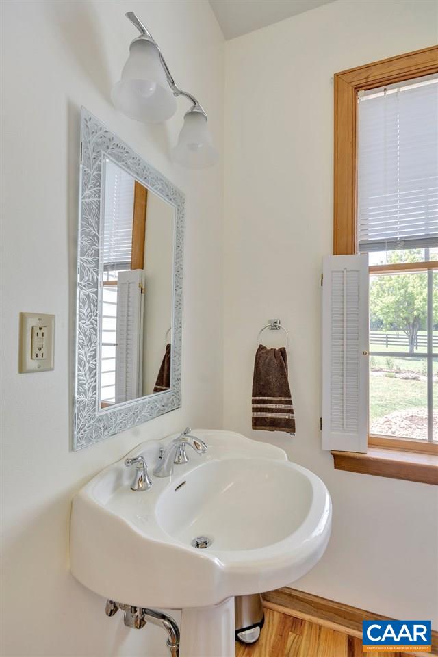 846 Troy Road Troy, VA 22974 - Photo 42 of 49 a bathroom with a sink and a large mirror