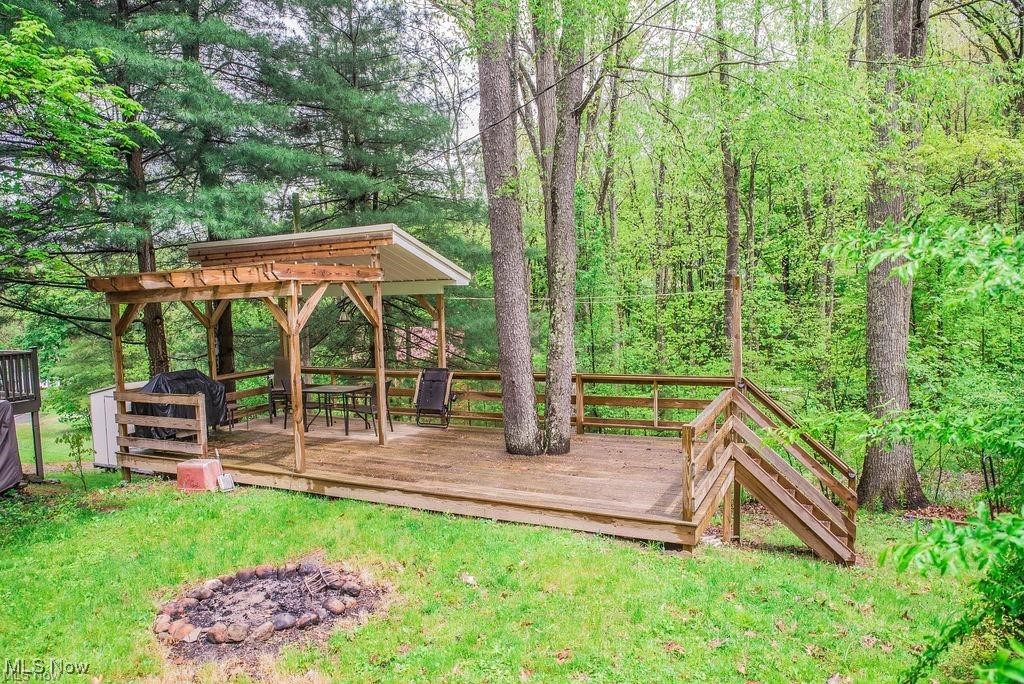 4254 Doral Road Southwest Carrollton, OH 44615 - Photo 17 of 46 View of grassy yard with a wooden deck