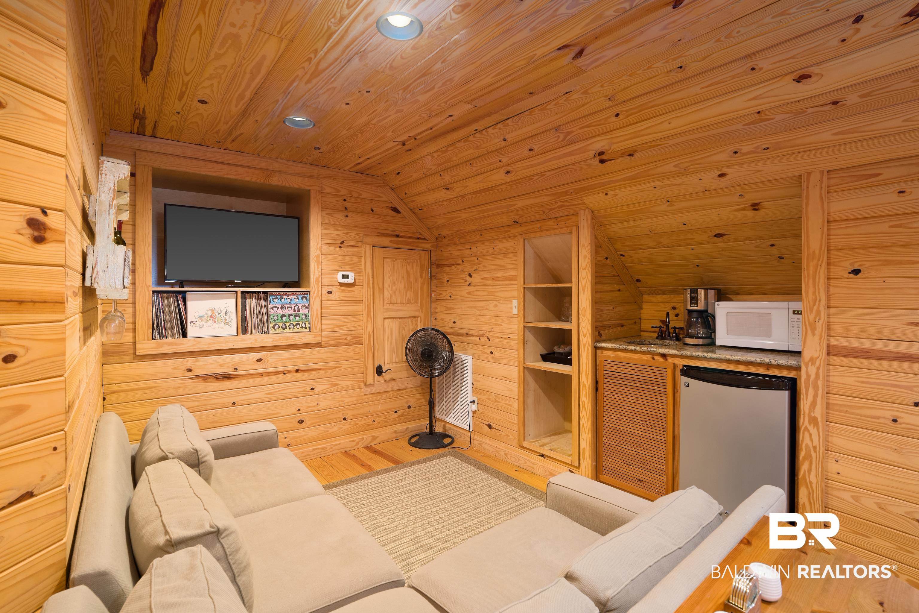 13253 Mary Ann Bch Road Fairhope, AL 36532 - Photo 32 of 54 Living room with wood-type flooring, lofted ceiling, wood ceiling, and wood walls