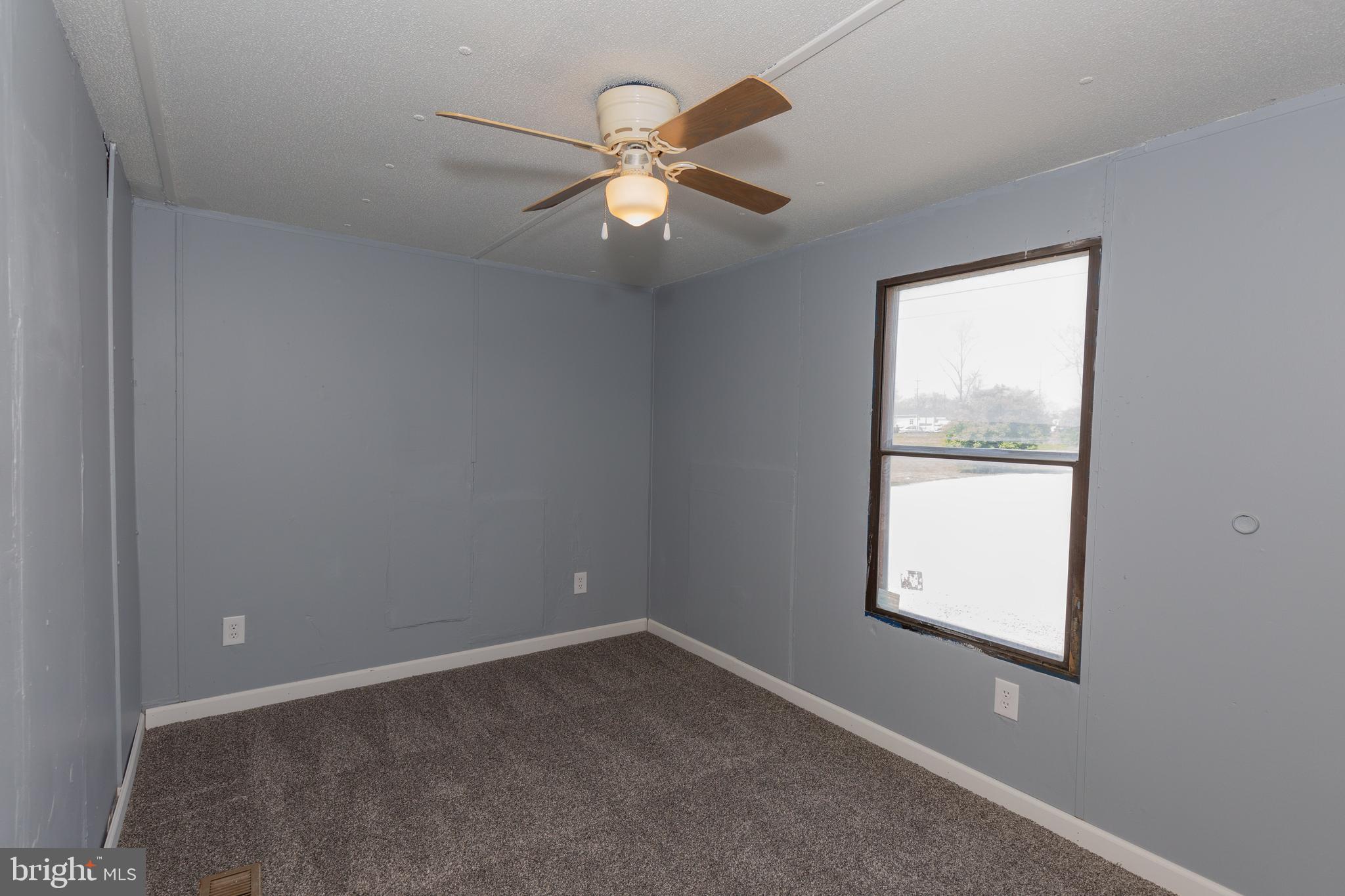 90 Fabric Drive Bunker Hill, WV 25413 - Photo 27 of 28 an empty room with a window and a fan
