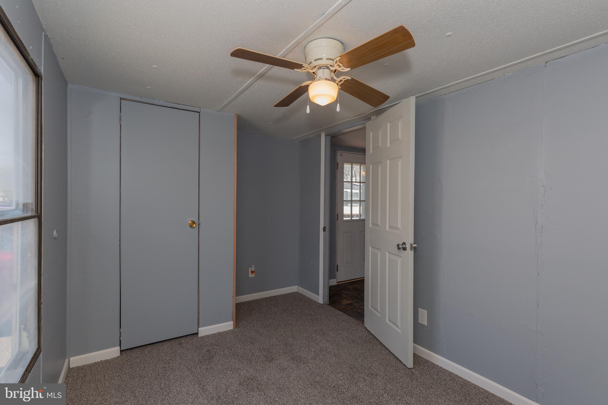 90 Fabric Drive Bunker Hill, WV 25413 - Photo 28 of 28 an empty room and hallway with windows
