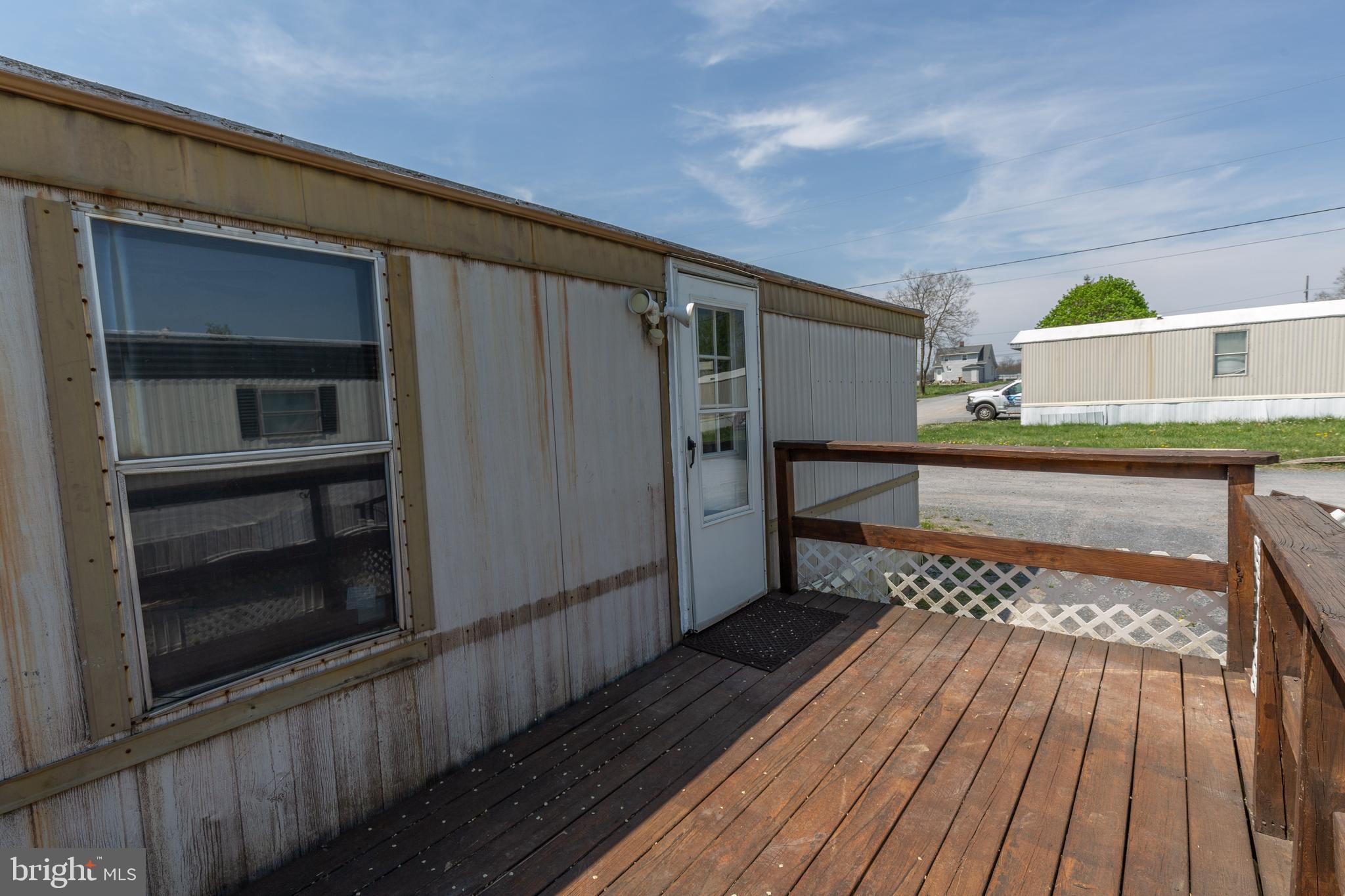 90 Fabric Drive Bunker Hill, WV 25413 - Photo 4 of 28 a hallway with wooden floor a fireplace and entryway