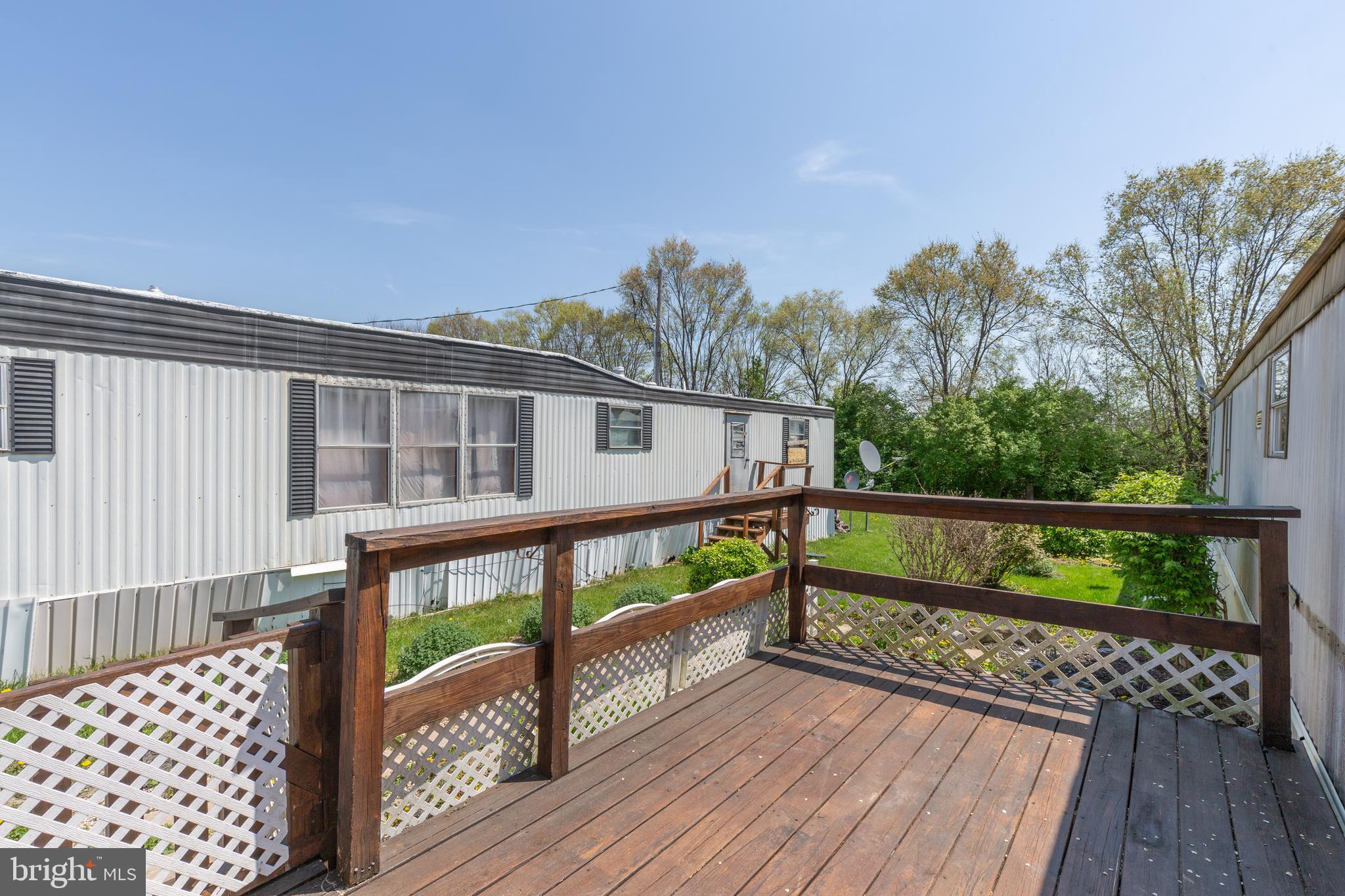 90 Fabric Drive Bunker Hill, WV 25413 - Photo 7 of 28 a view of balcony with wooden floor and fence