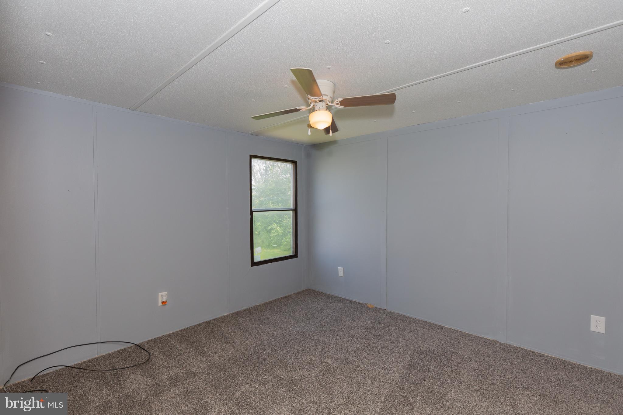 90 Fabric Drive Bunker Hill, WV 25413 - Photo 8 of 28 a view of an empty room with a window