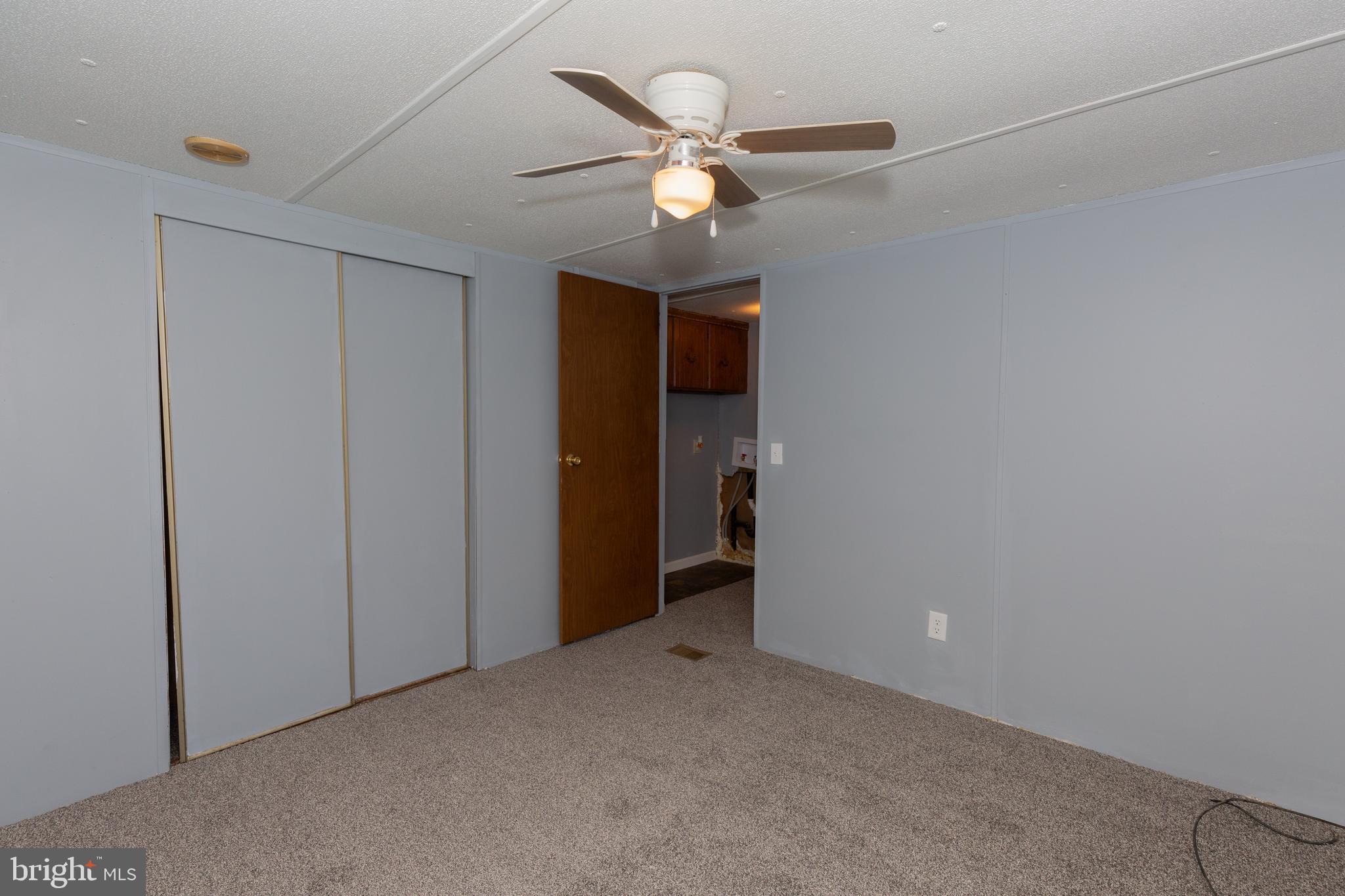 90 Fabric Drive Bunker Hill, WV 25413 - Photo 9 of 28 an empty room with closet and ceiling fan