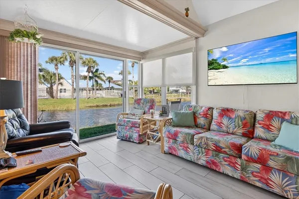 a living room with furniture and a floor to ceiling window