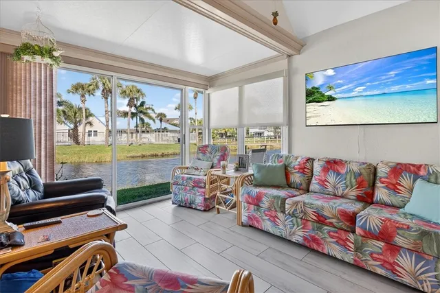 a living room with furniture and a floor to ceiling window
