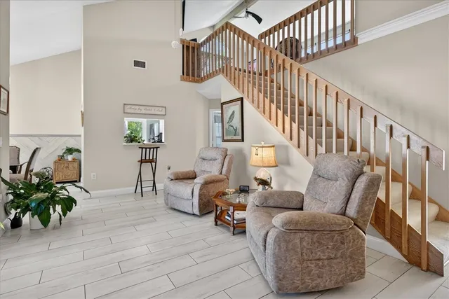 a living room with furniture and a potted plant
