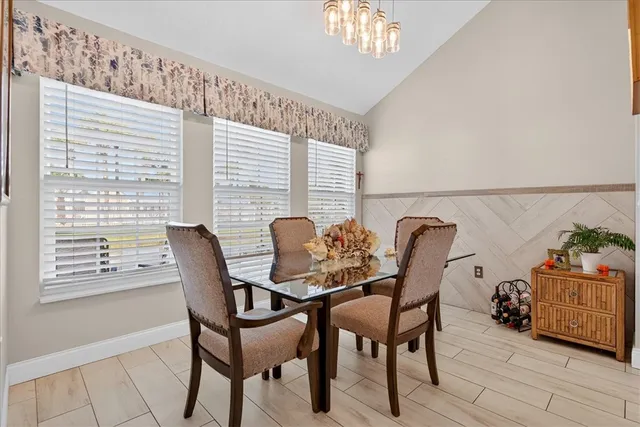 a view of a dining room with furniture and chandelier