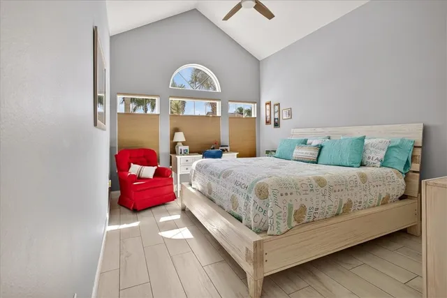 a bedroom with a bed a window and dresser