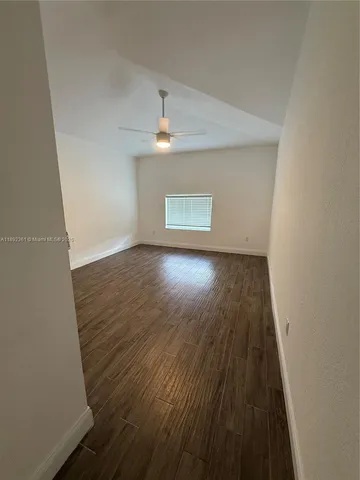 a view of wooden floor and a chandelier in a room