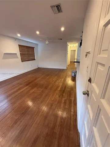 an entryway of a house with wooden floor