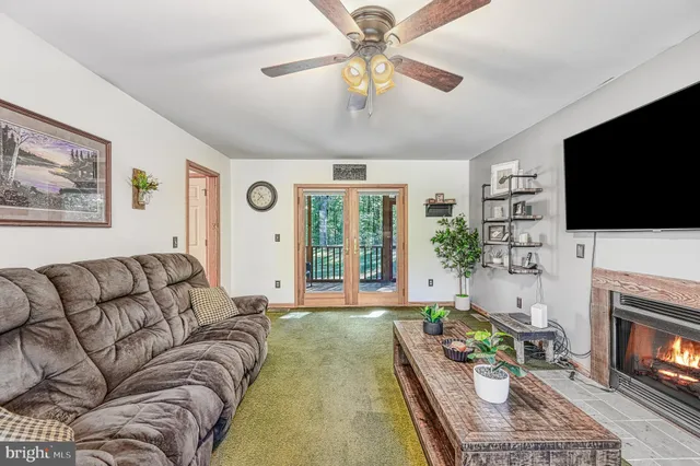 a living room with furniture fireplace and flat screen tv